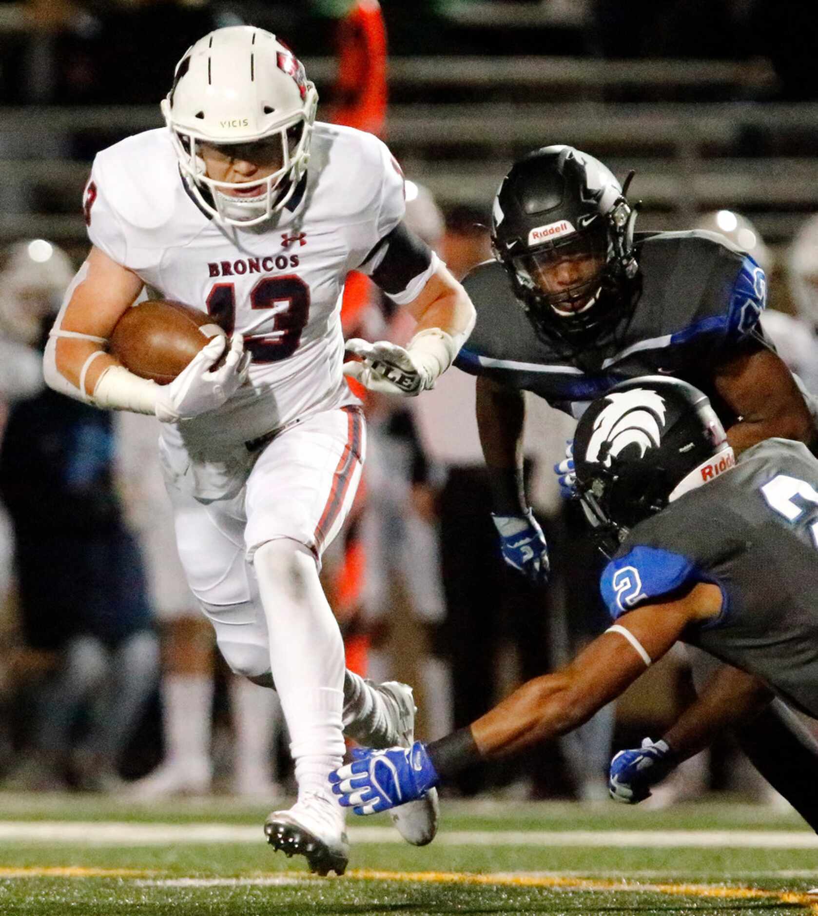 McKinney Boyd High School running back Jake Fex (13) carries the football for first down...