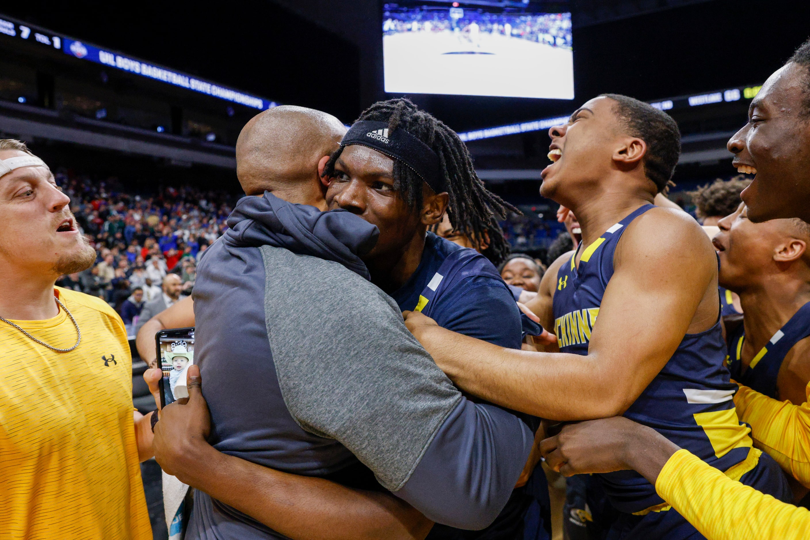 McKinney guard Alex Anamekwe (center) is swarmed by teammates after a game-winner in double...