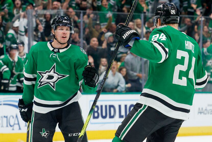 Stars defenseman Miro Heiskanen (4) celebrated his goal with center Roope Hintz (24) during...