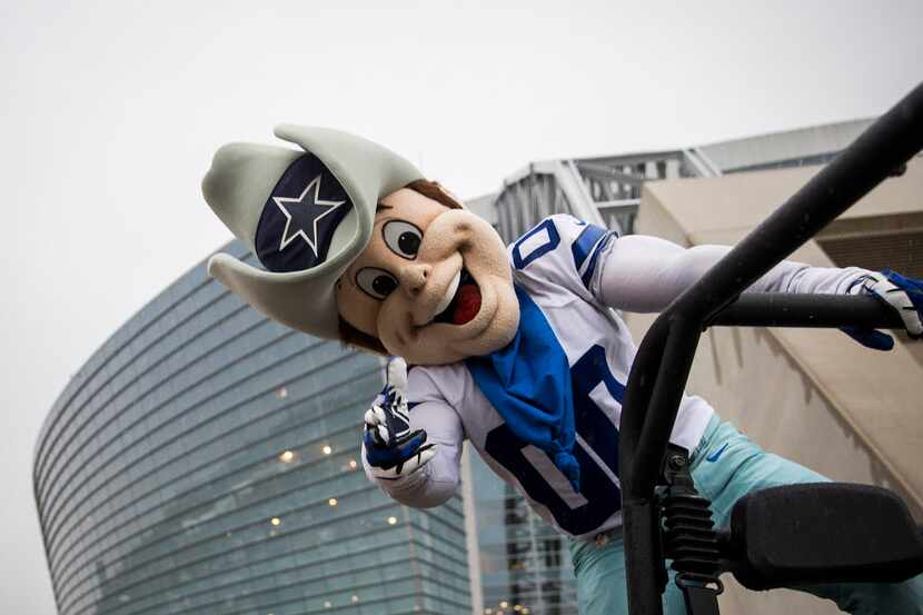 Rain doesn't dampen the spirits of Dallas Cowboys mascot Rowdy outside the stadium before an...