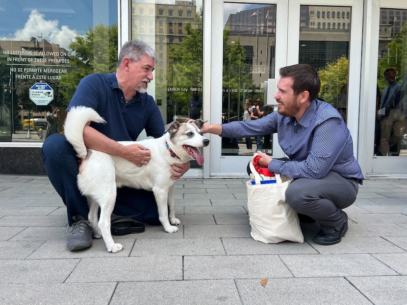 DJ Loggins (left) and DallasNews Corp. staffer Brandon Handy with Loggins' dog, Patches, in...