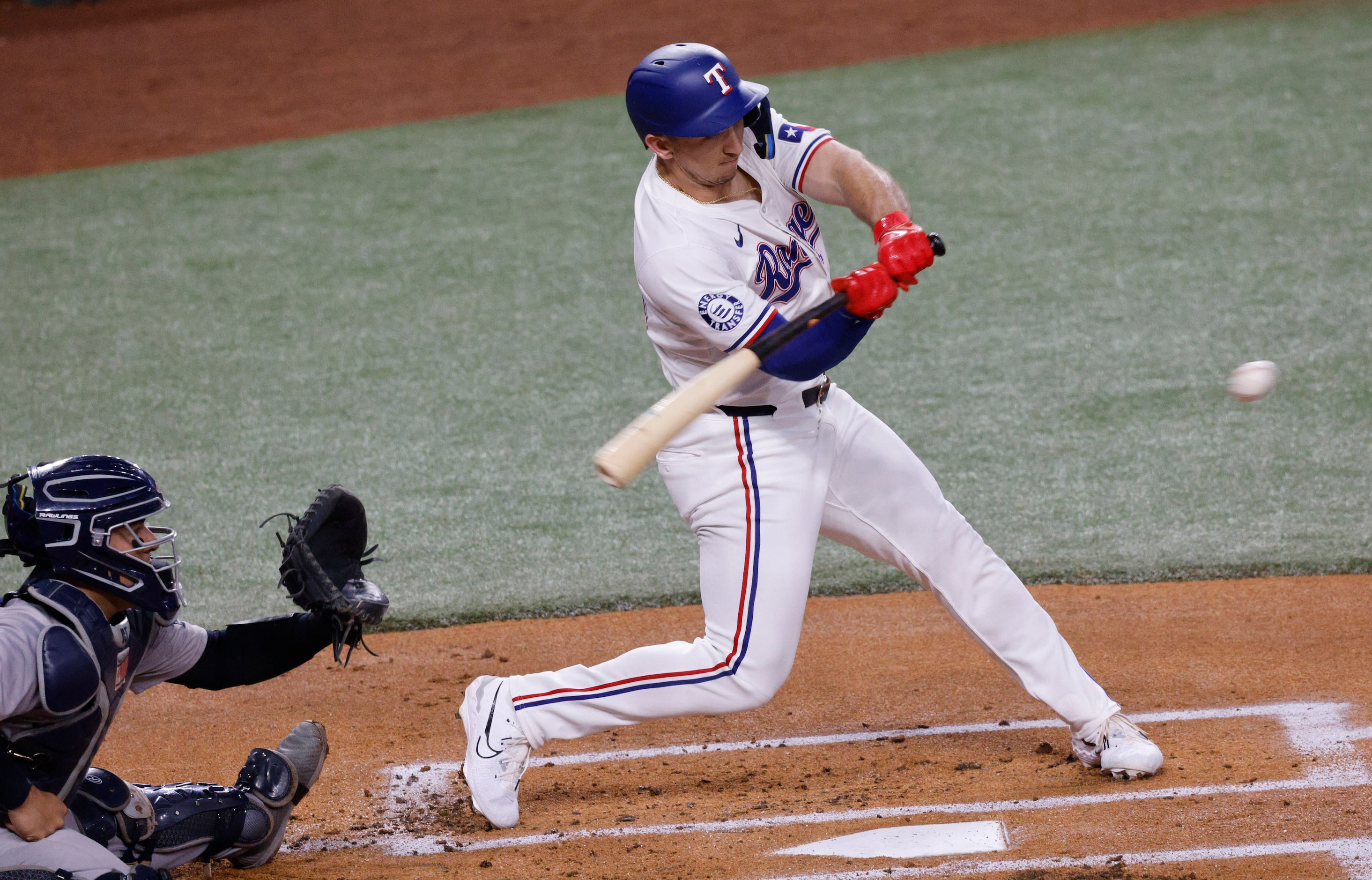 Texas Rangers outfielder Wyatt Langford (36) hits a single during the first inning of a...