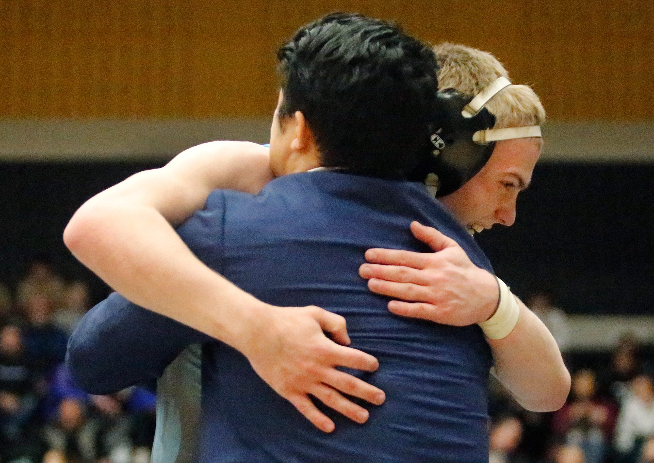 Xavier Jukes of Prsoper Rock Hill High School embraces his coach after winning the 145...