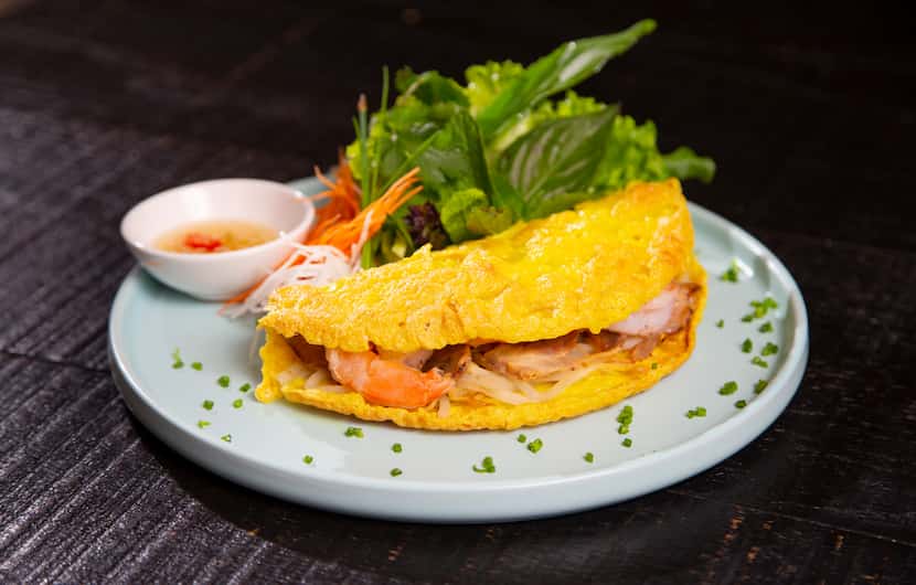 Bánh xèo is a Vietnamese crepe made with shrimp and sliced pork.