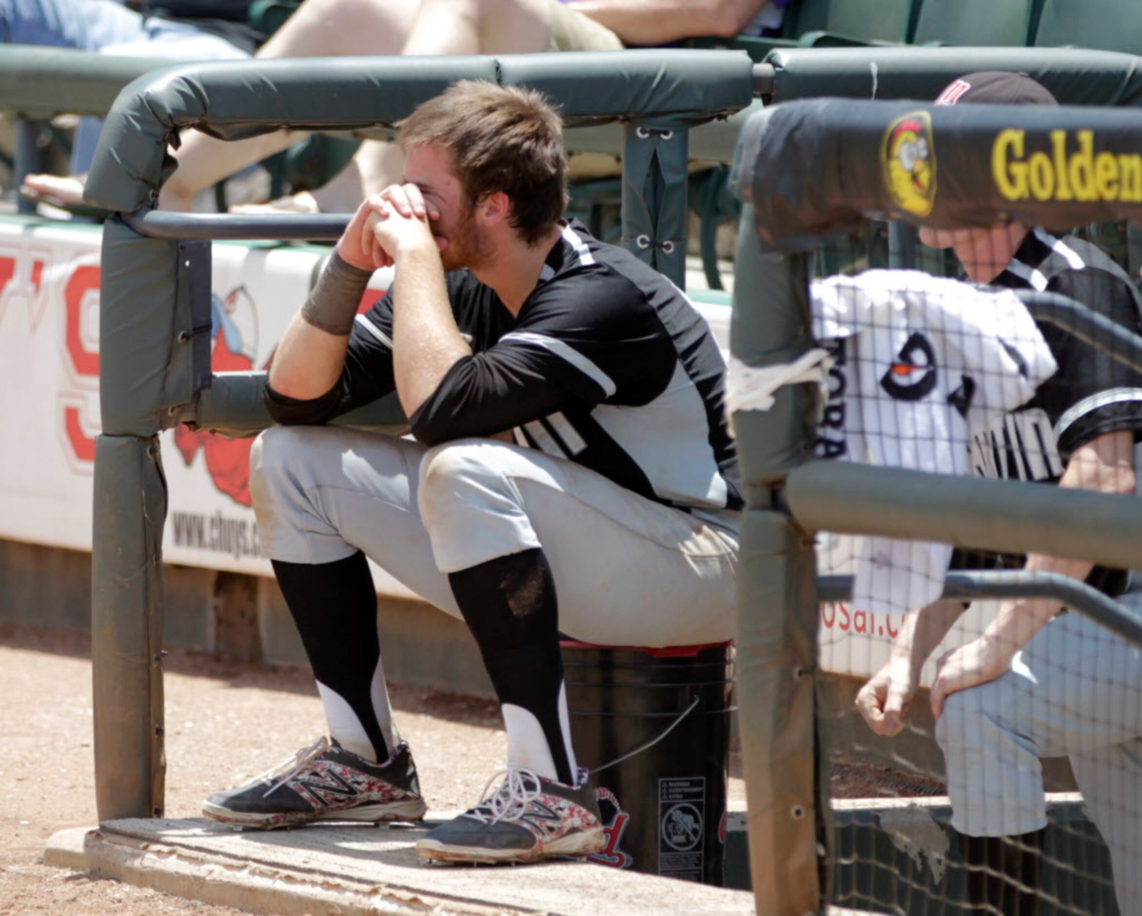 Martin's Aaron Fanning (27) sits dejected by the dugout as Cypress Ranch celebrates their...