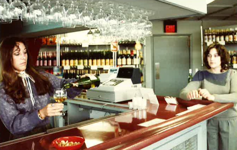 Martha Zelzer pours sister Carol Zelzer a glass of wine