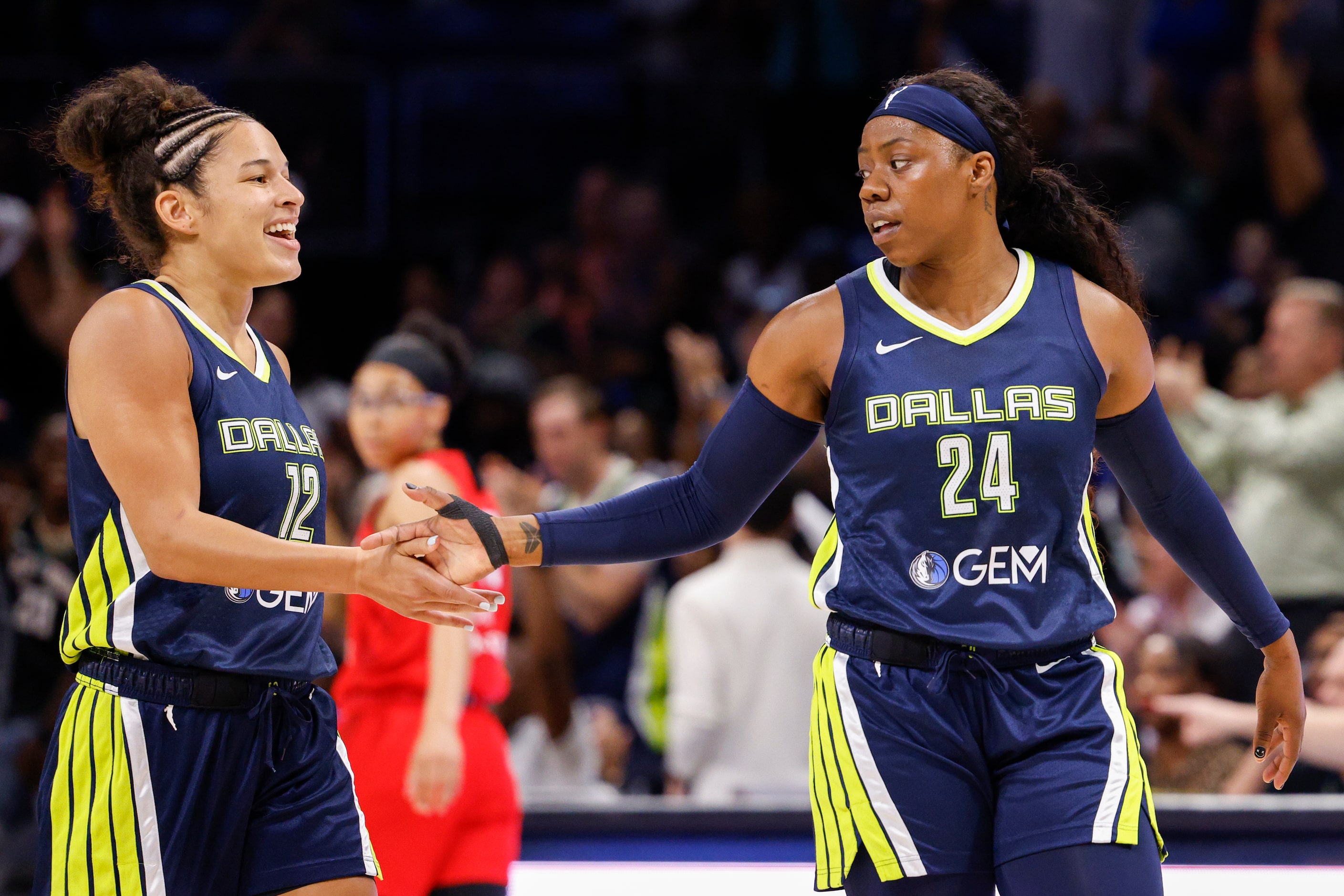 Dallas Wings guard Arike Ogunbowale (24) celebrates her three-point shot with guard Veronica...