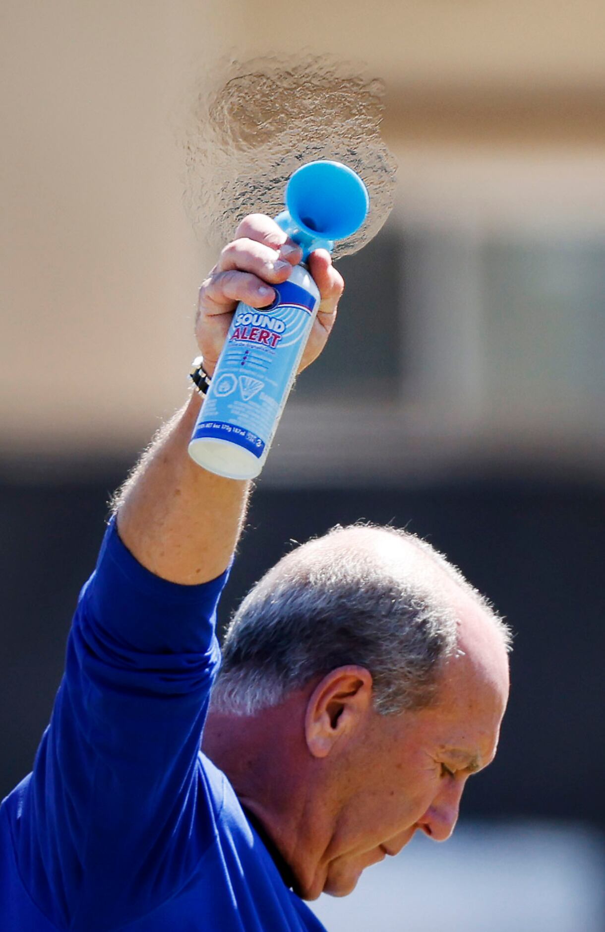 Dallas Cowboys equipment manager Bucky Buchanan blows an air horn to end a walk-thru at...