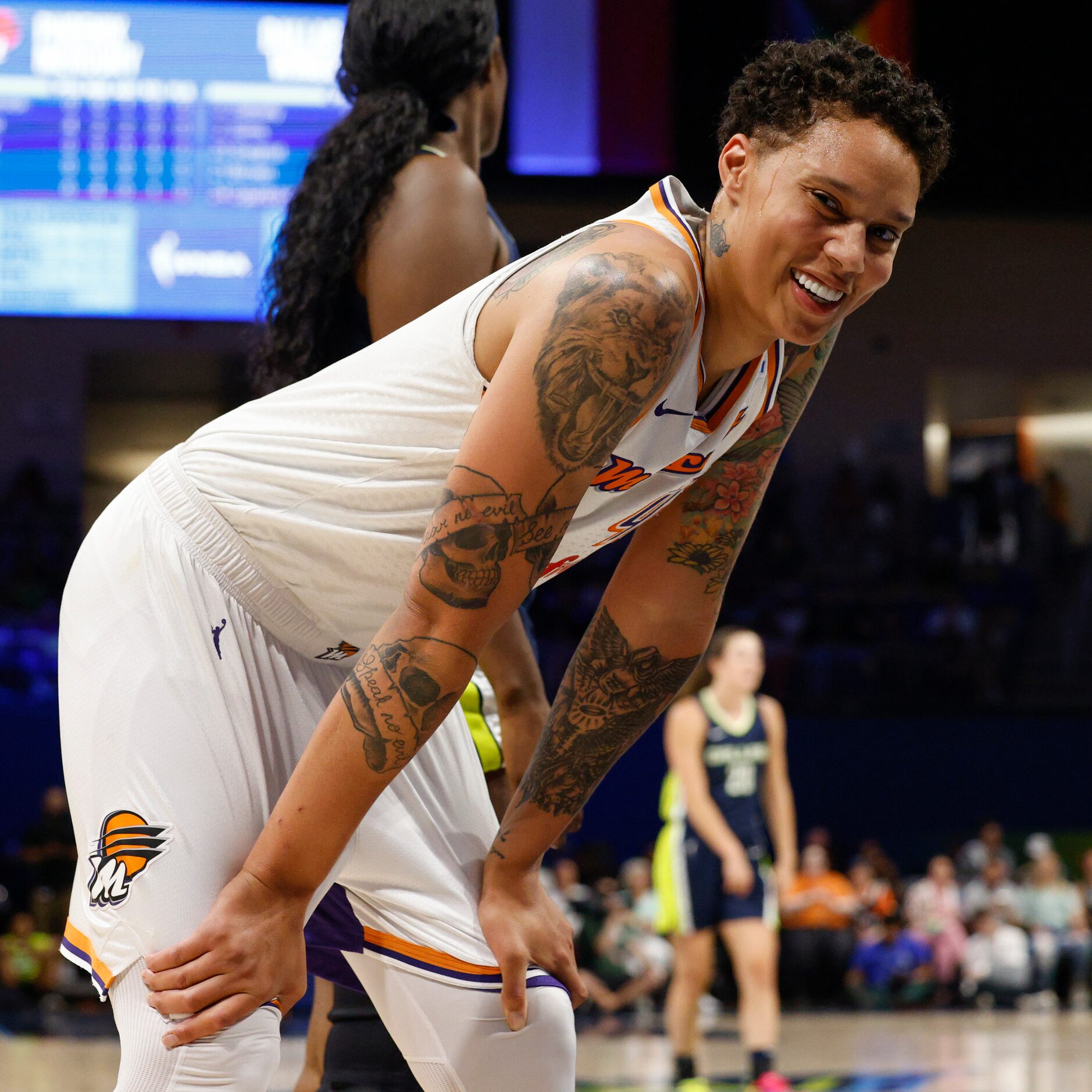 Phoenix Mercury center Brittney Griner (42) smiles after a fan says “I love you B.G.” during...