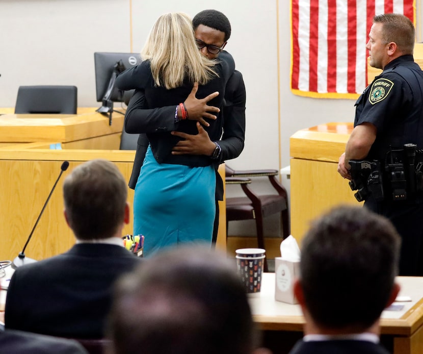 Botham Jean's younger brother Brandt Jean hugs former Dallas officer Amber Guyger after...