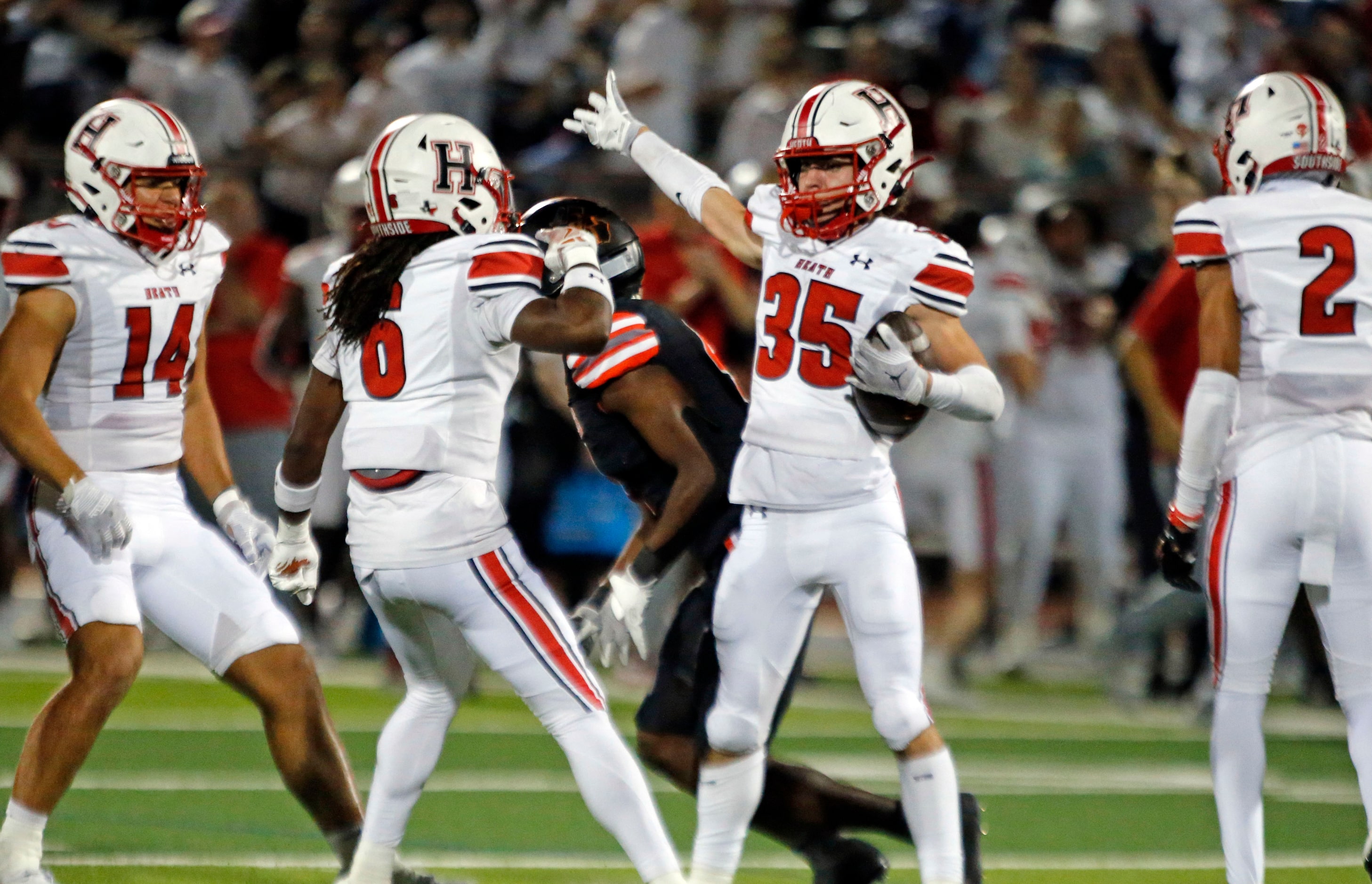 Rockwall Heath High Colton Laughery (35) celebrates with teammates after making an...