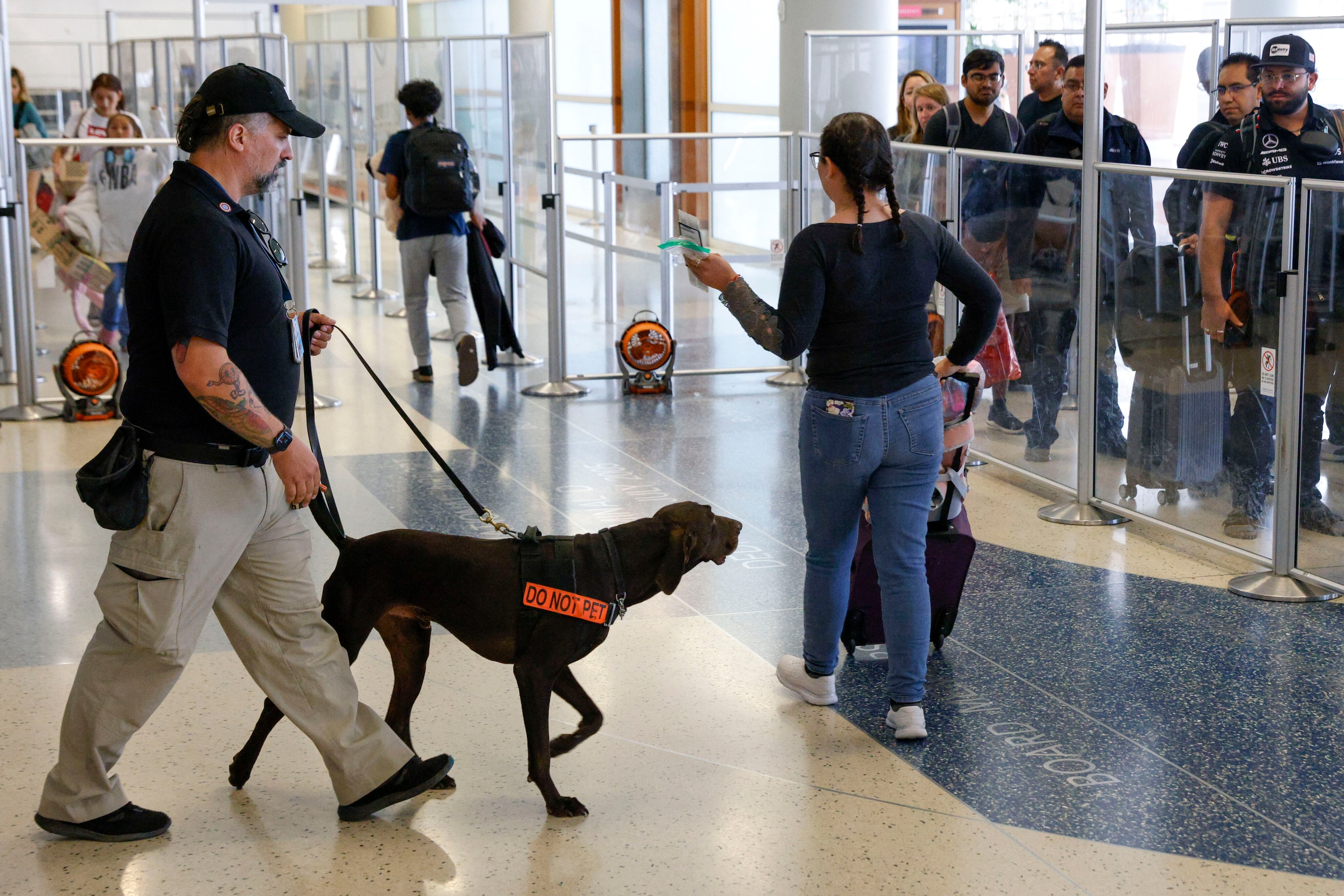 Explosive K-9 detection handler Kevin Farren walks explosive detection K-9 Dusan, a...