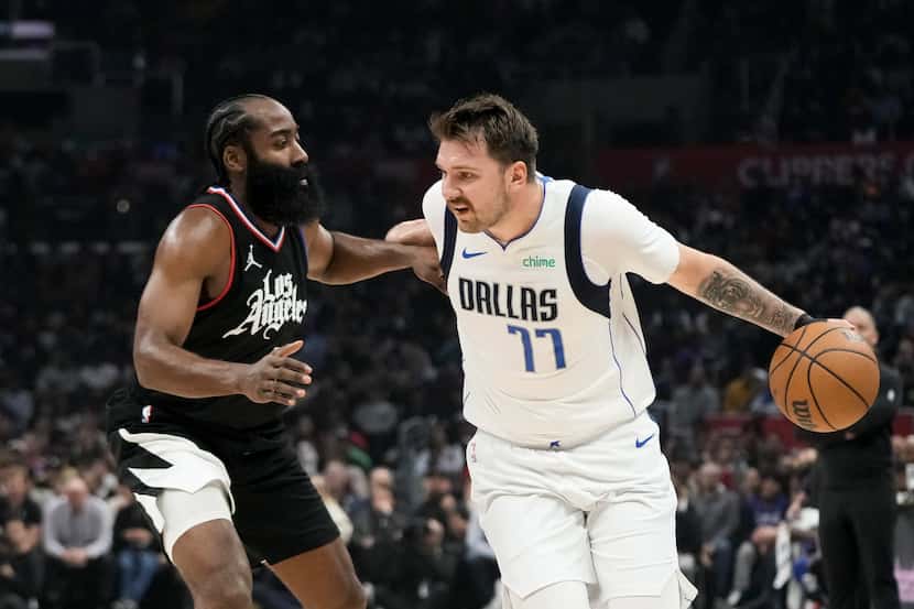 Los Angeles Clippers' James Harden, left, pressures Dallas Mavericks' Luka Doncic during the...