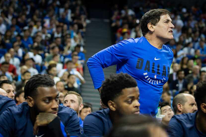 Dallas Mavericks owner Mark Cuban stands up to argue a call during the first half of an NBA...