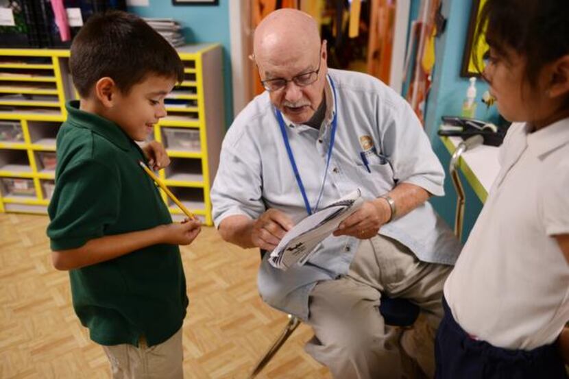 
Jagers, 91, a World War II Navy veteran and author, helps Steven Aguilar, 6, with his...