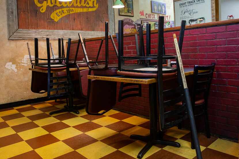 Empty tables at Goldrush Cafe on March 16, 2020 in Dallas. The outbreak of the new...