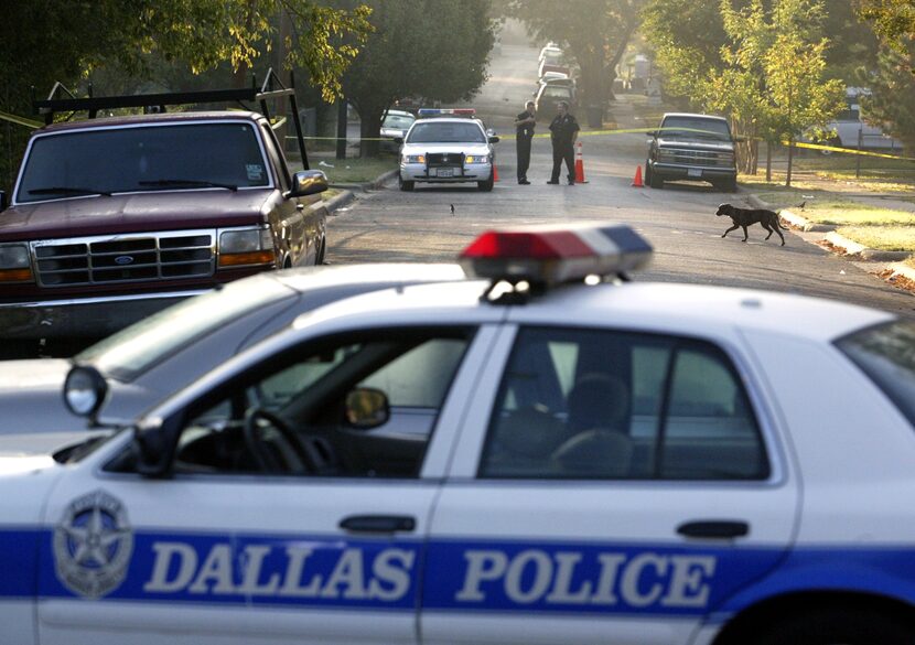 DPD officers help secure the crime scene Nov. 13, 2005, in the area where a police pursuit...