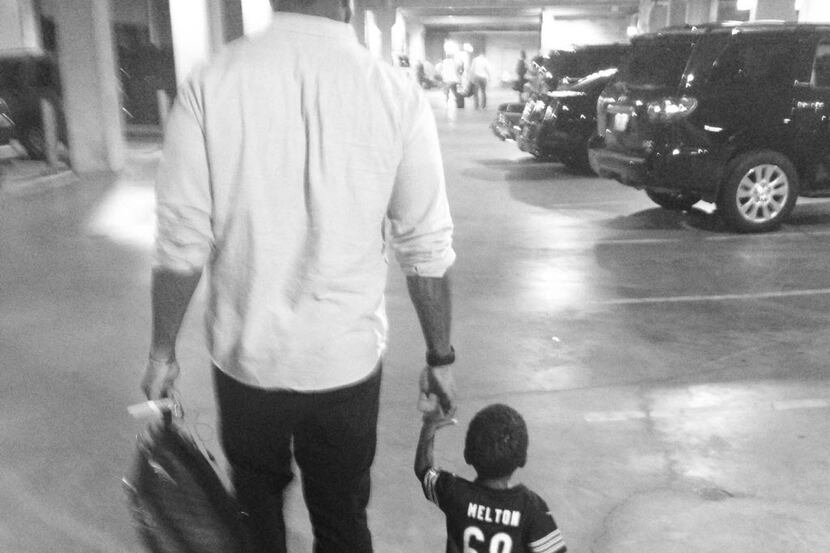 Former Bears defensive tackle Henry Melton walks with his nephew, 2-year-old Tyce.