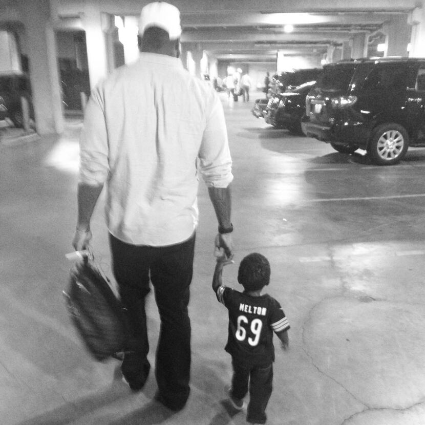 Former Bears defensive tackle Henry Melton walks with his nephew, 2-year-old Tyce.