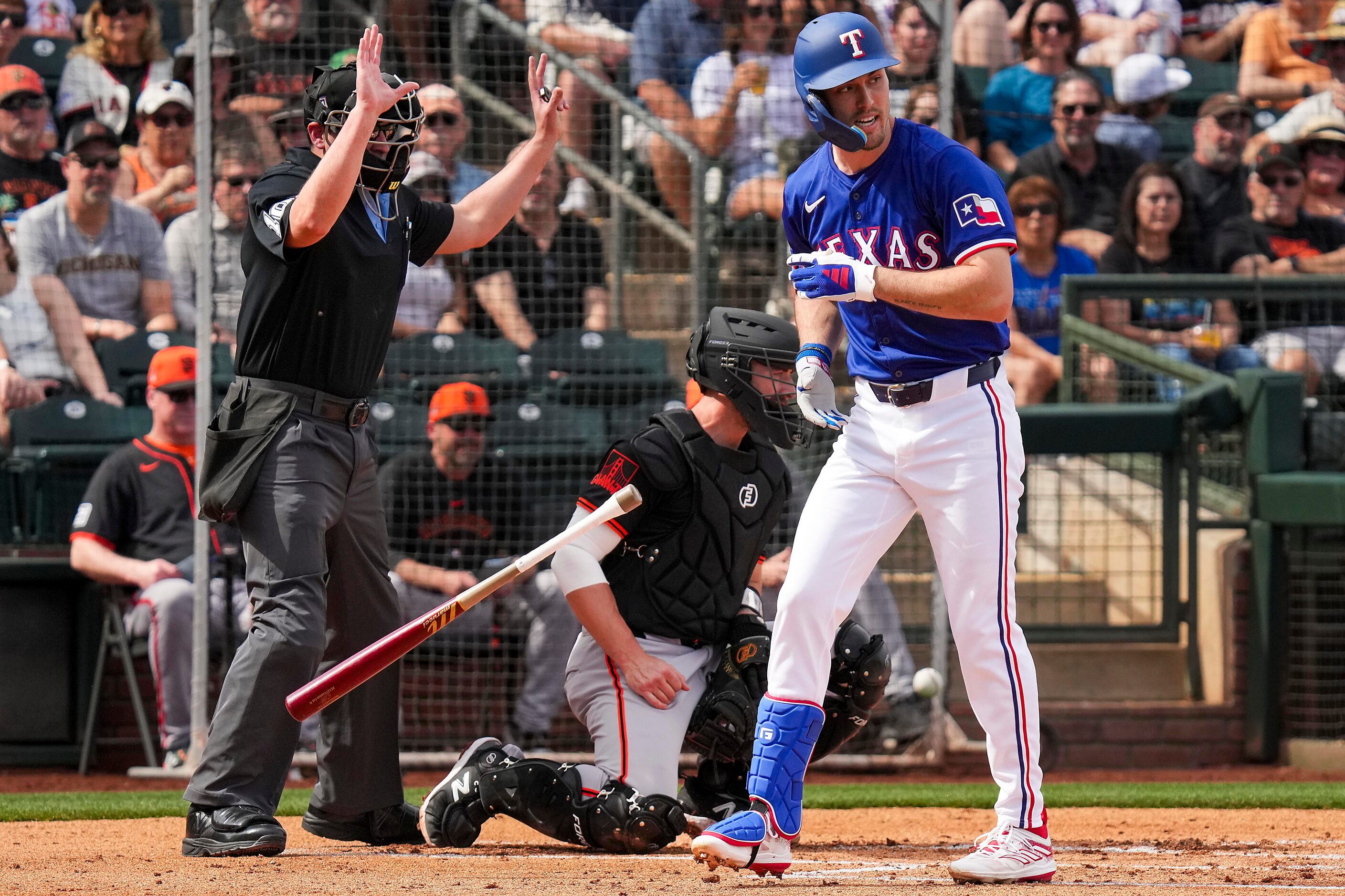 Texas Rangers outfielder Evan Carter reacts after being hit by a pitch during the first...