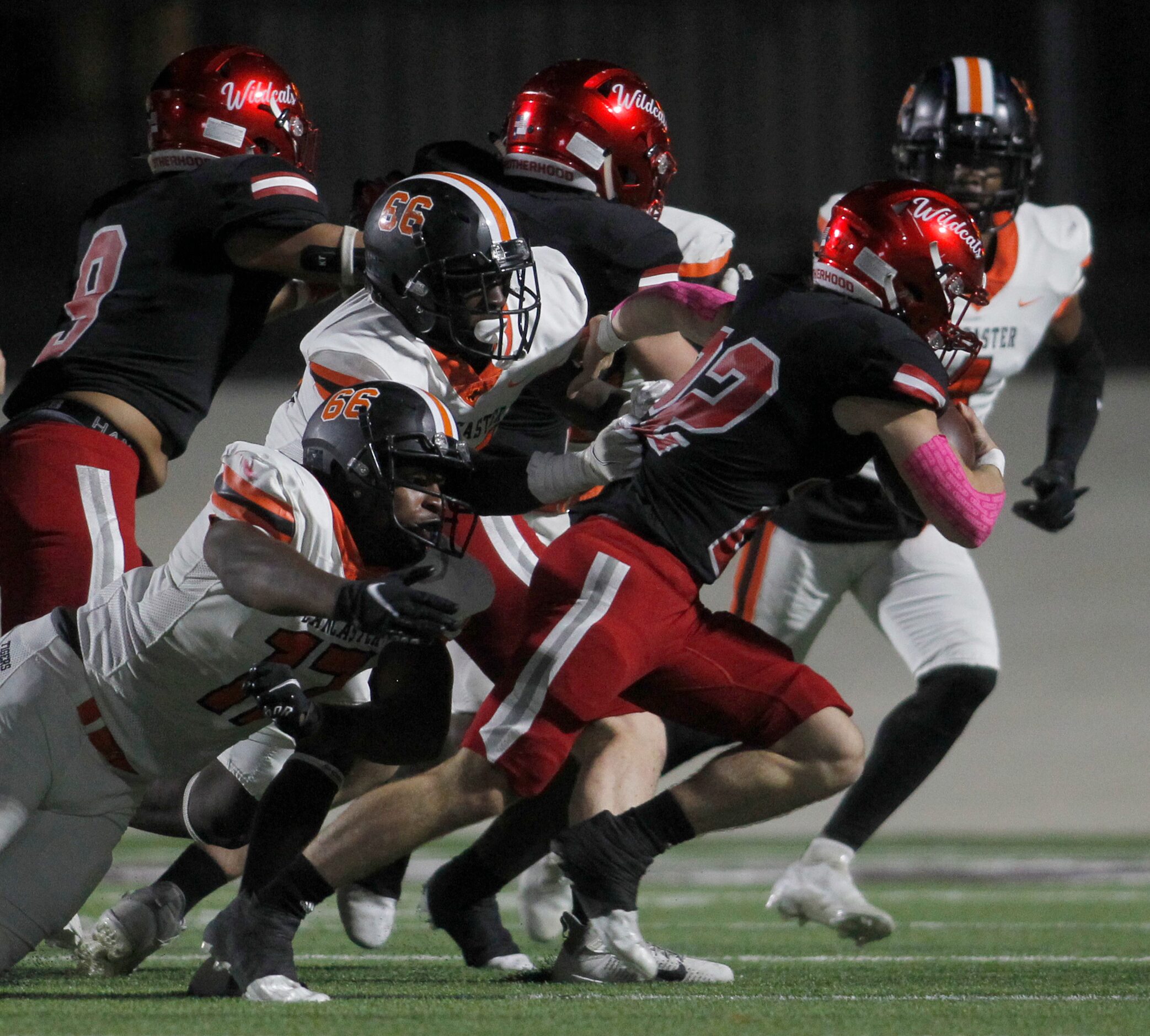 Dallas Woodrow Wilson running back Nathan Barrilleaux (22) is corralled by Lancaster...