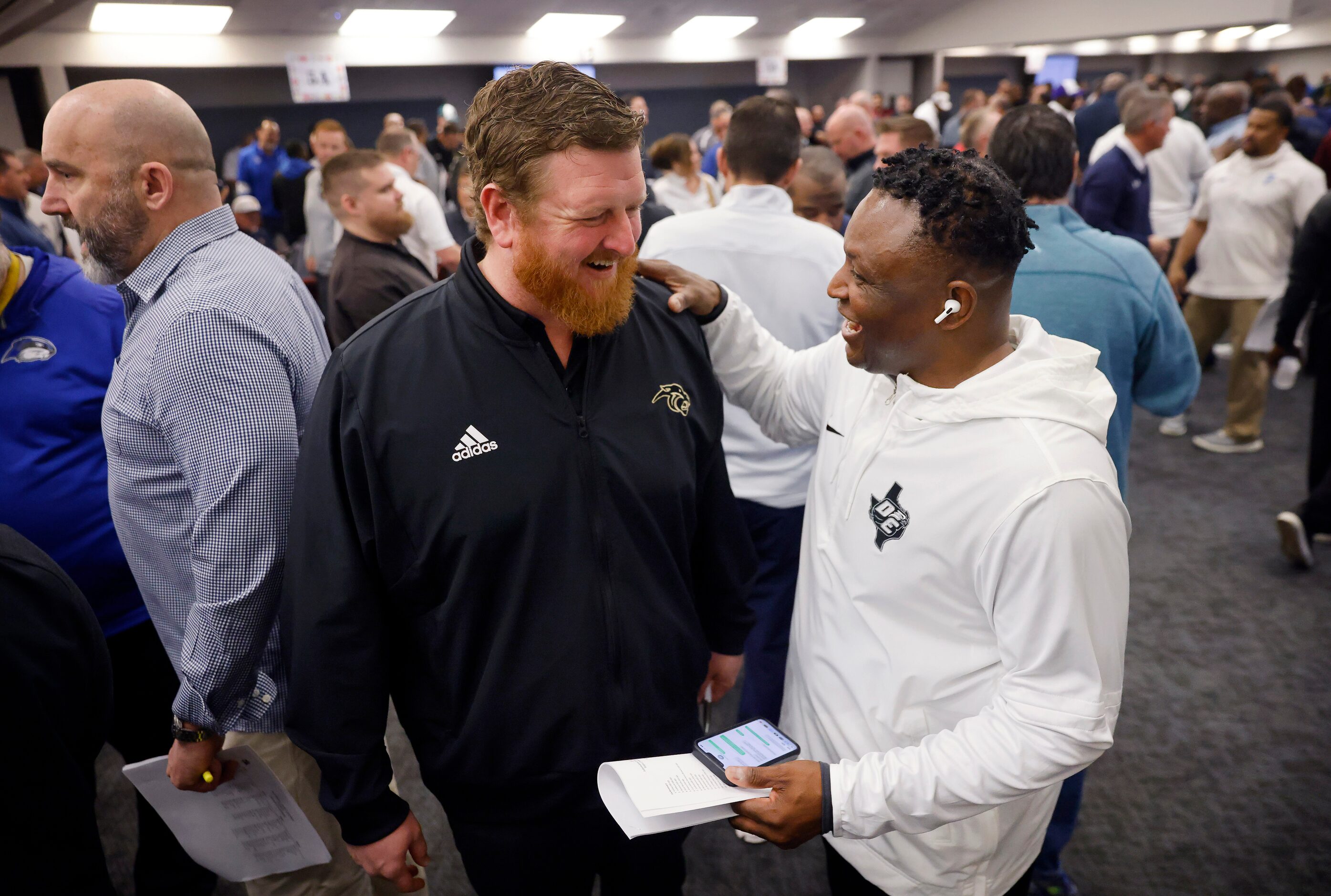 Plano East offensive coordinator David Joeckel (left) catches up with his former head coach...