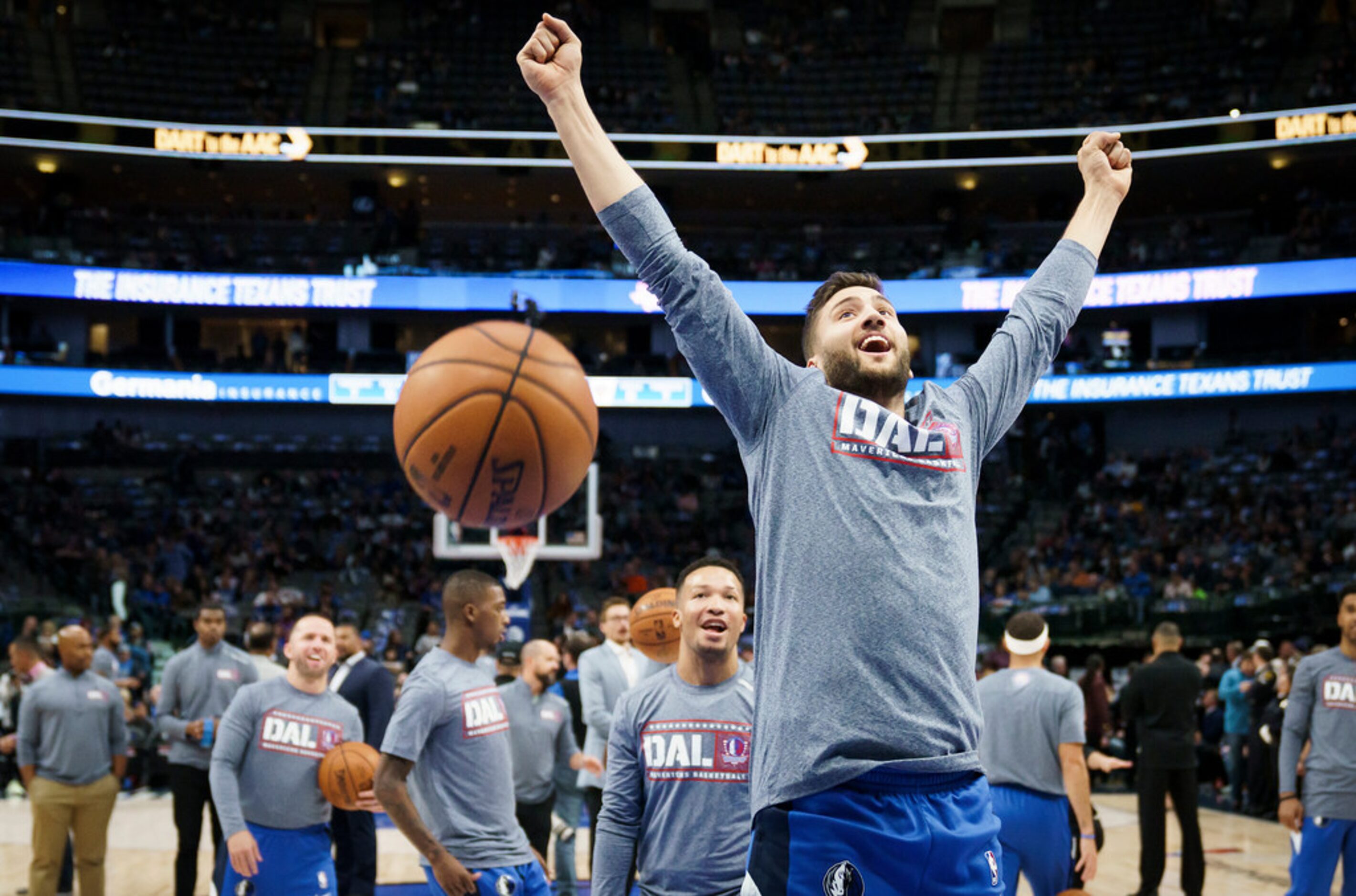 Dallas Mavericks center Maxi Kleber cheers a basket by guard Luka Doncic as the team warms...