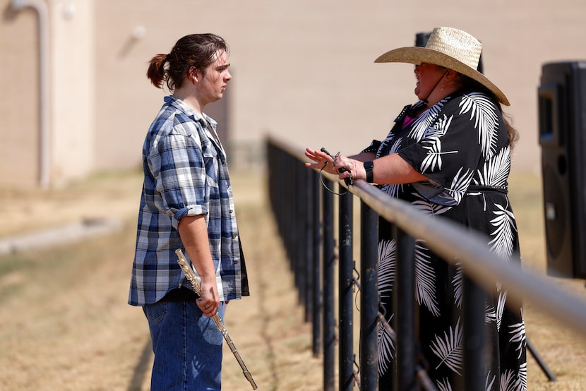 Jareth Vickery, 17 (left), talks with Valley View High School band director Shannon Worley...