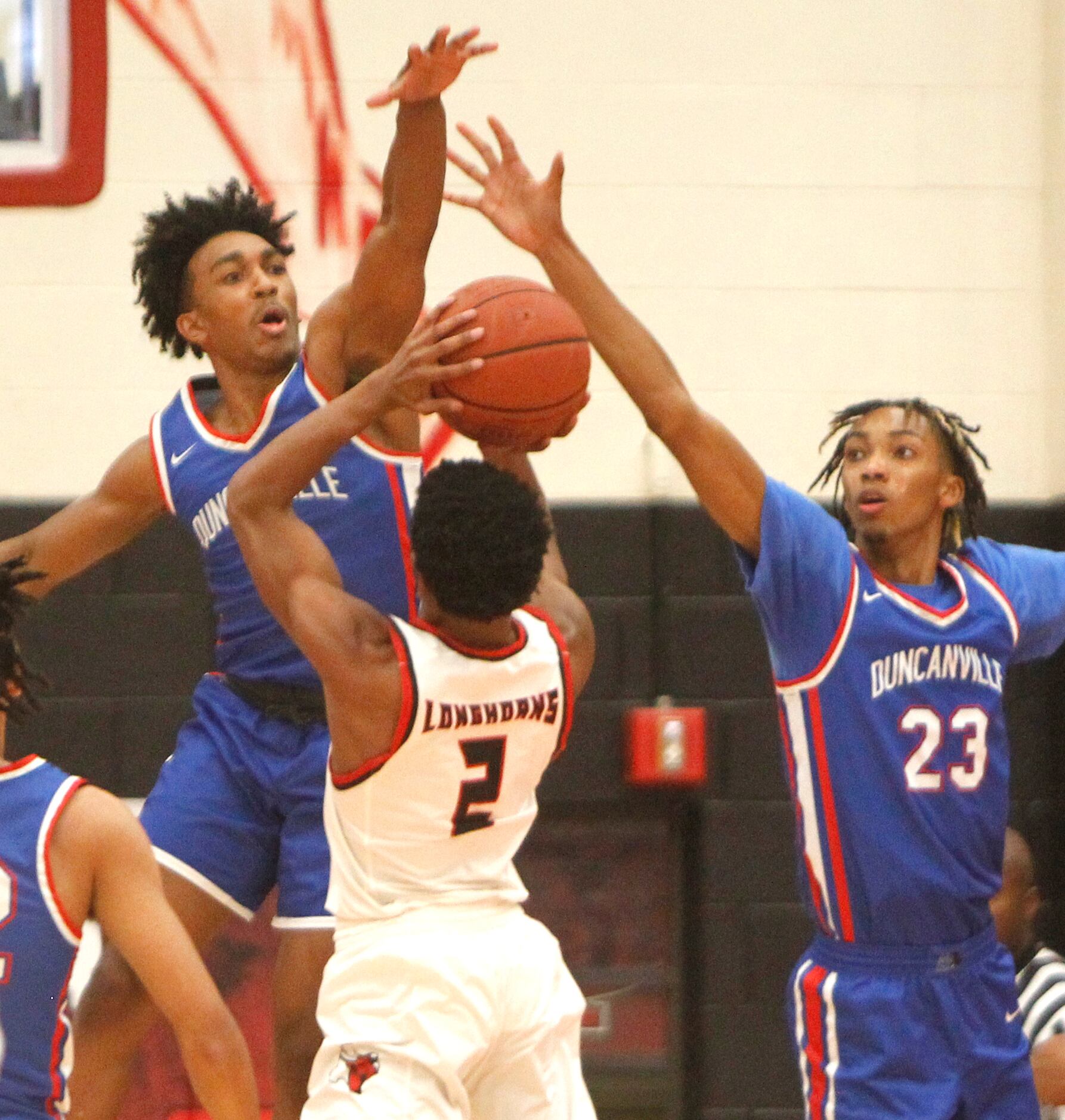 Cedar Hill's Jason Justice (2) attempted a tall task in clearing a shot over Duncanville...