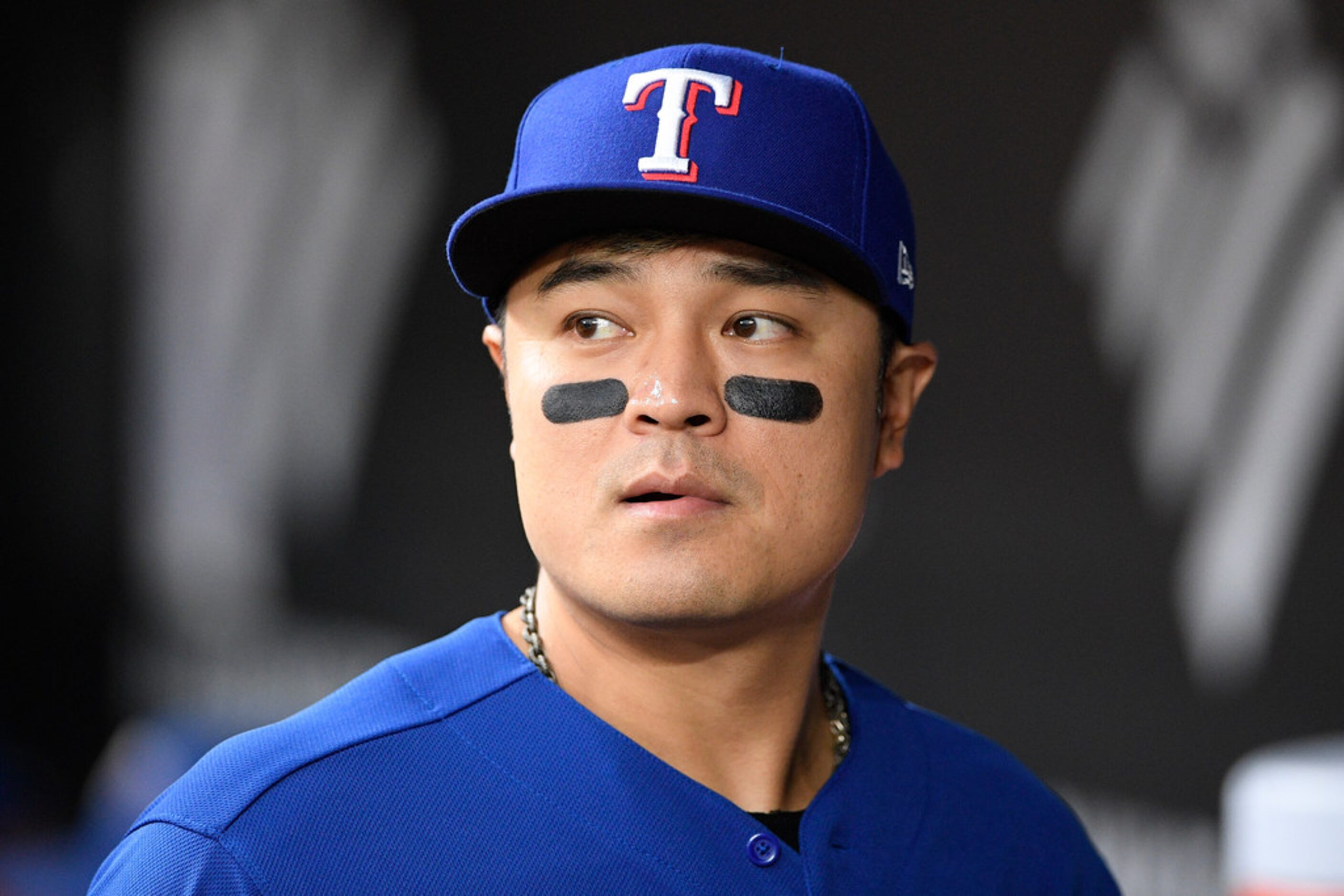 Texas Rangers' Shin-Soo Choo, of South Korea, looks on from the dugout before a baseball...