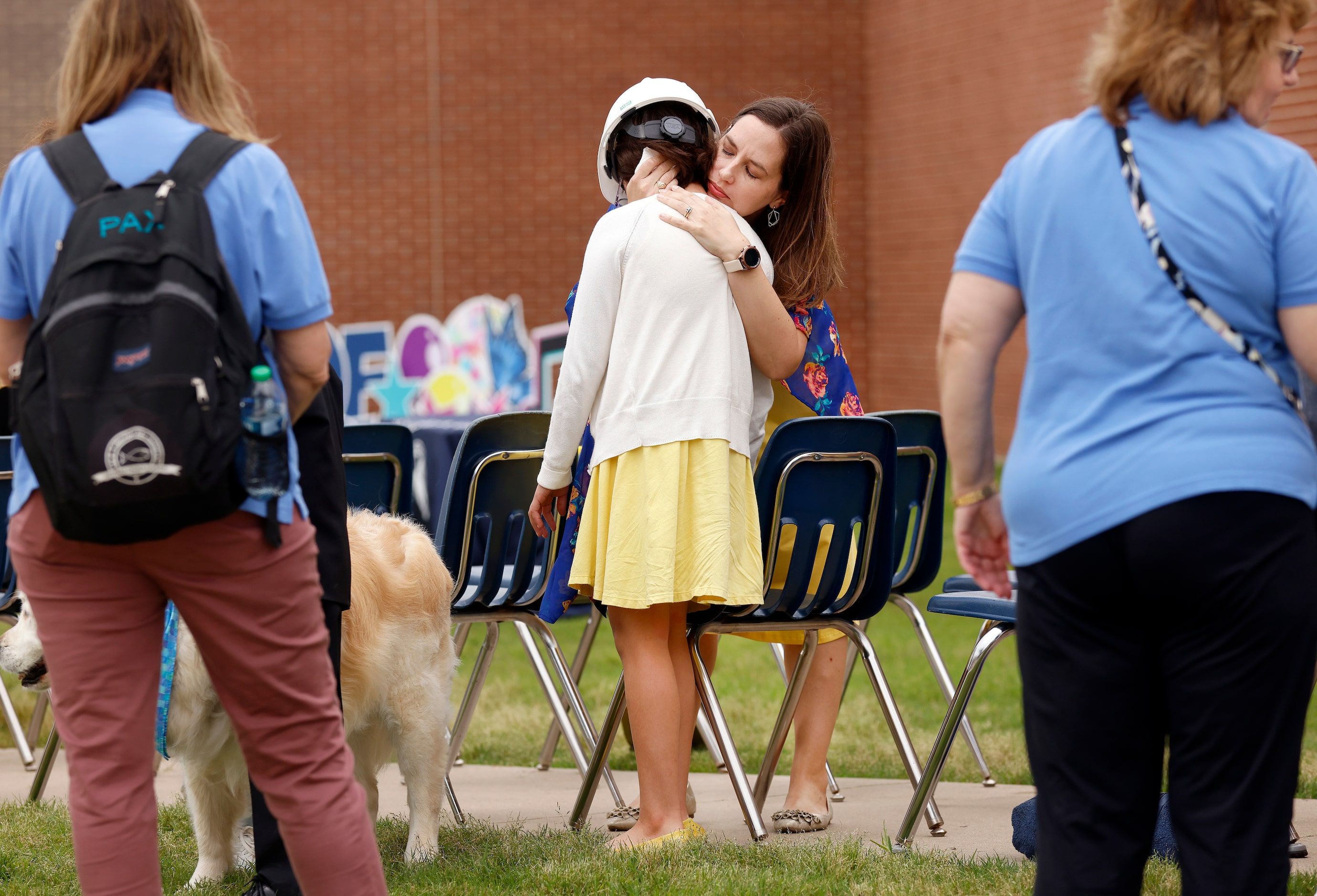 Teacher Lisa Baez comforts her daughter and third grade student Isabel Baez following a...