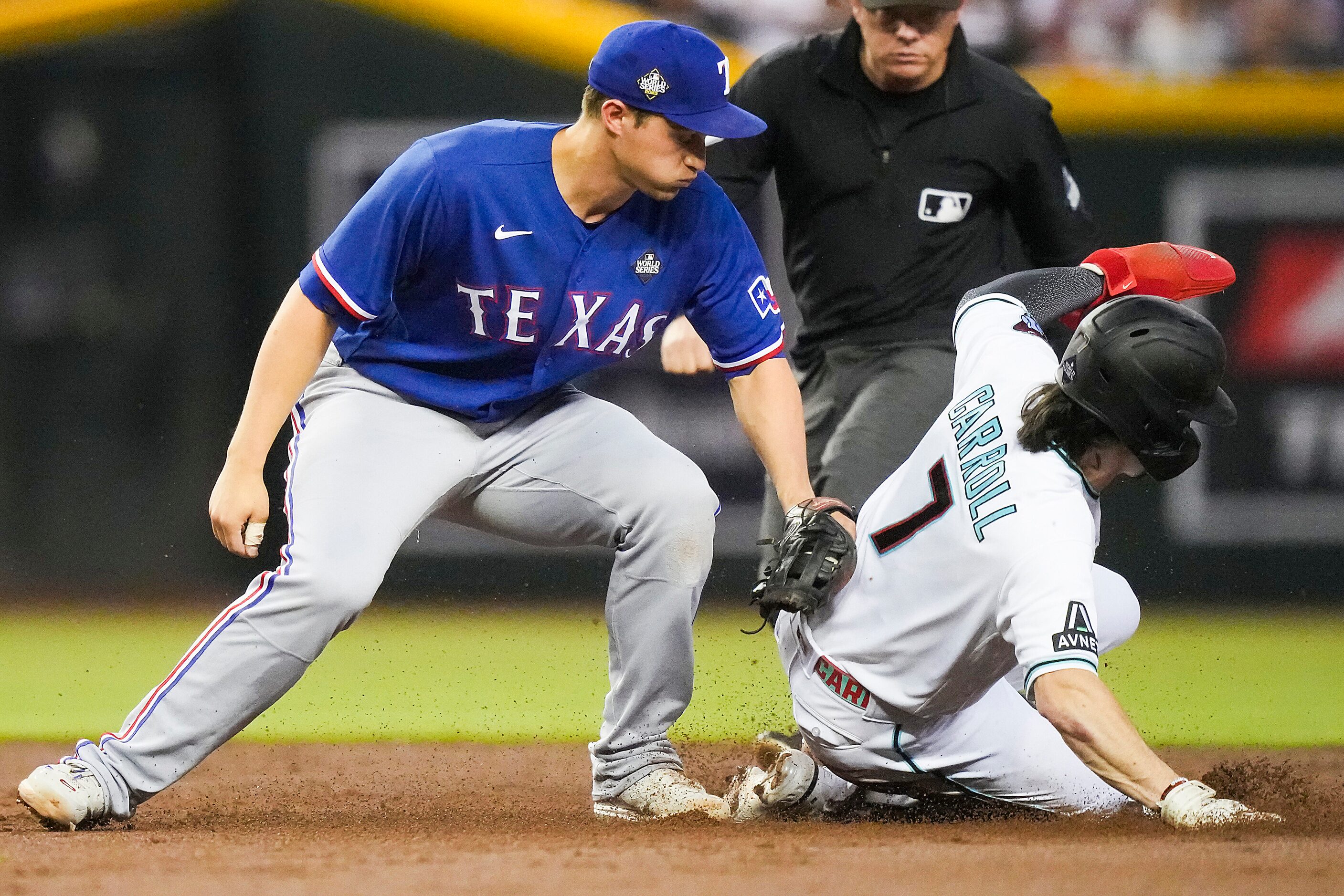 Arizona Diamondbacks’ Corbin Carroll steals second ahead of the tag from Texas Rangers...