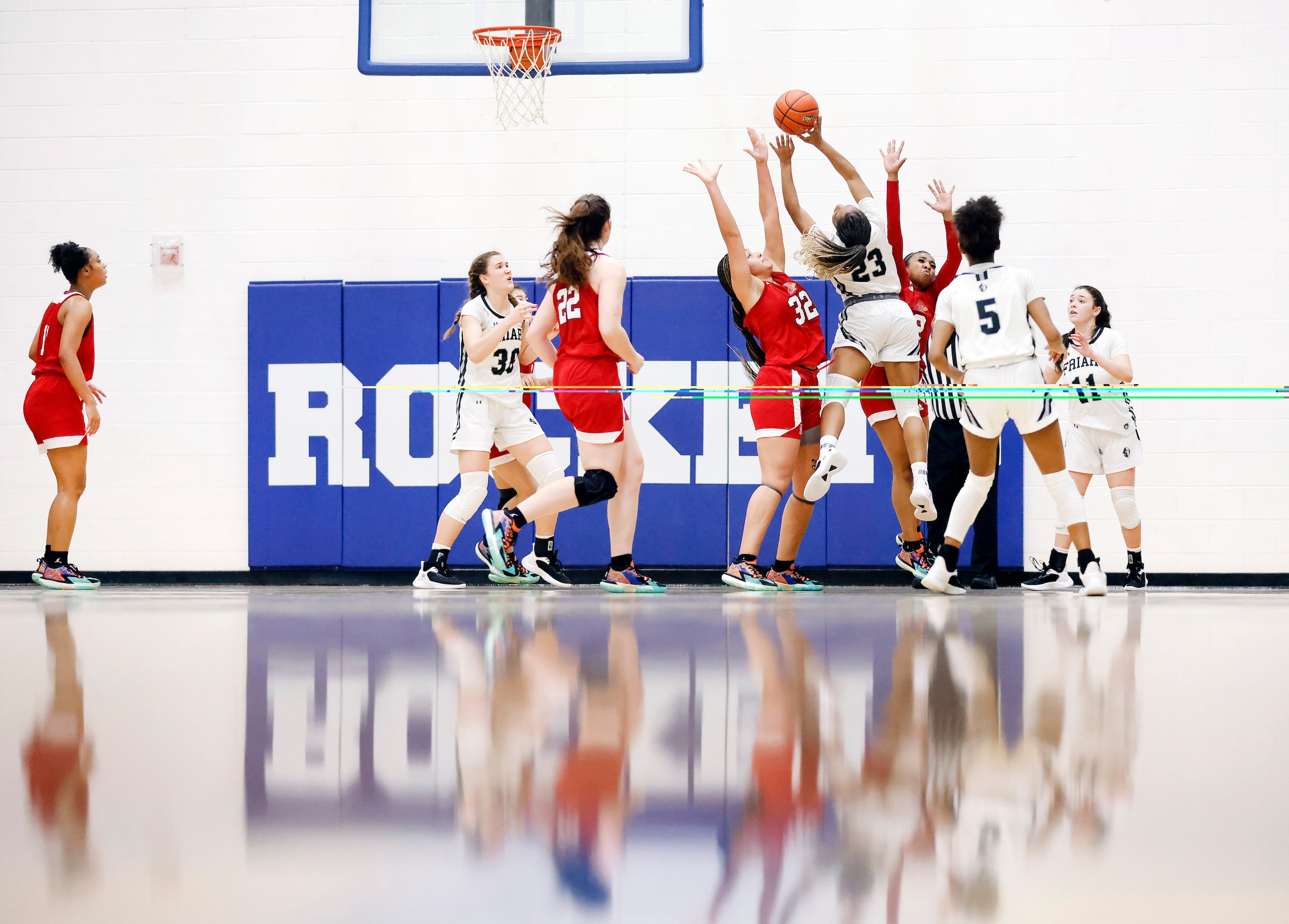 Bishop Lynch guard Mikah Ford (23) puts up a shot over John Paul II forward Allysia McDaniel...