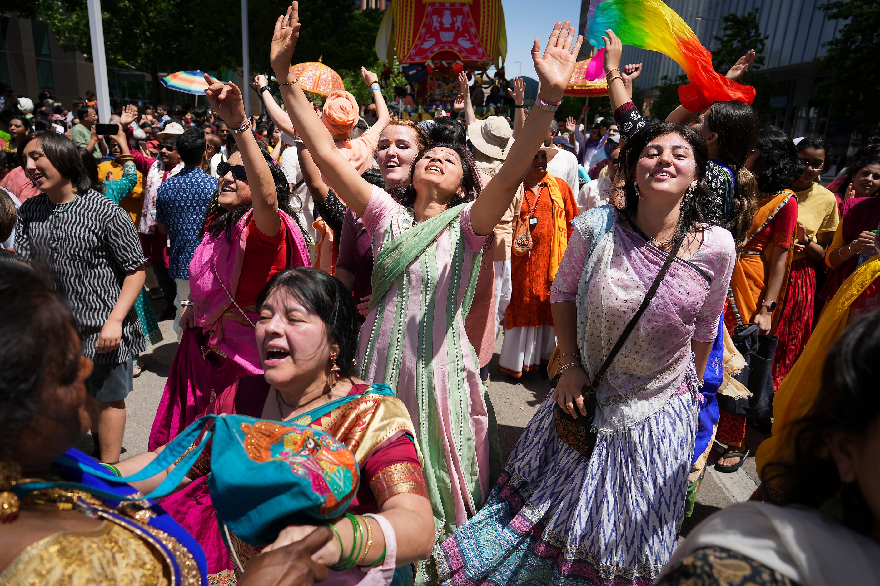 Revelers participating in the Ratha Yatra parade dance down Ross Avenue downtown during the...