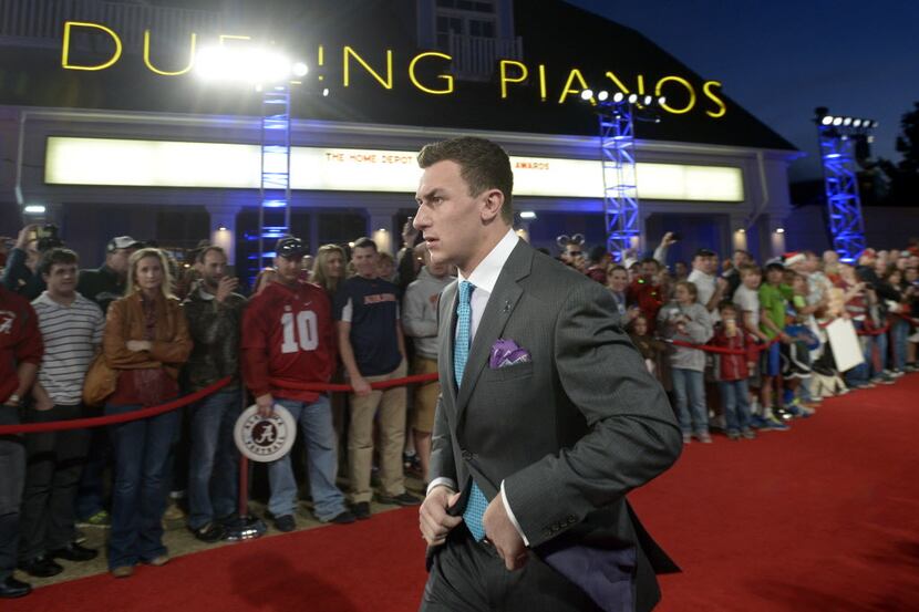 Texas A&M quarterback Johnny Manziel arrives on the red carpet for the College Football...