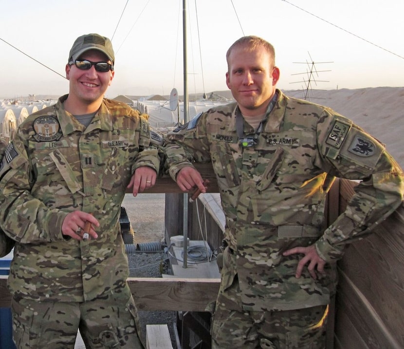 Justin "Buddy"  Lee (left) enjoys a cigar with fellow Chinook pilot Bryan Nichols at Forward...