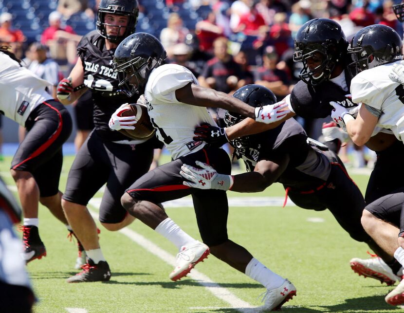 In this file photo, Texas Tech wide receiver Jakeem Grant pushes his way past defenders...