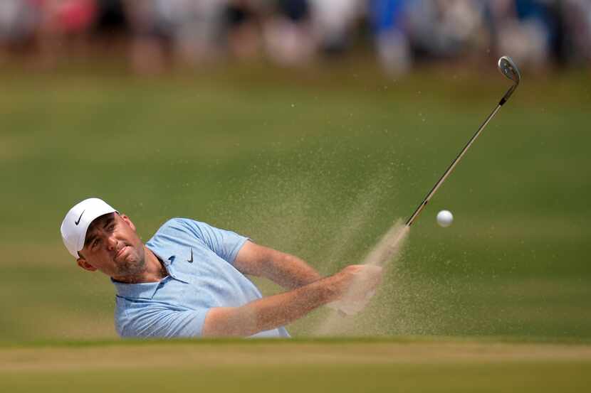 Scottie Scheffler hits from the bunker on the 10th hole during the third round of the U.S....