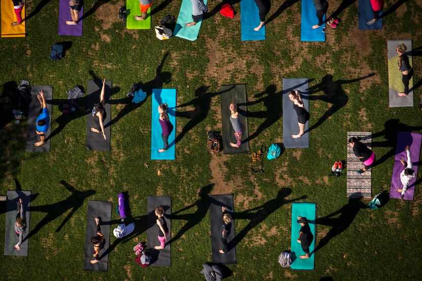 Dallas Yoga Center hosts a yoga class at Kylde Warren Park on Saturday, March 25, 2017, in...