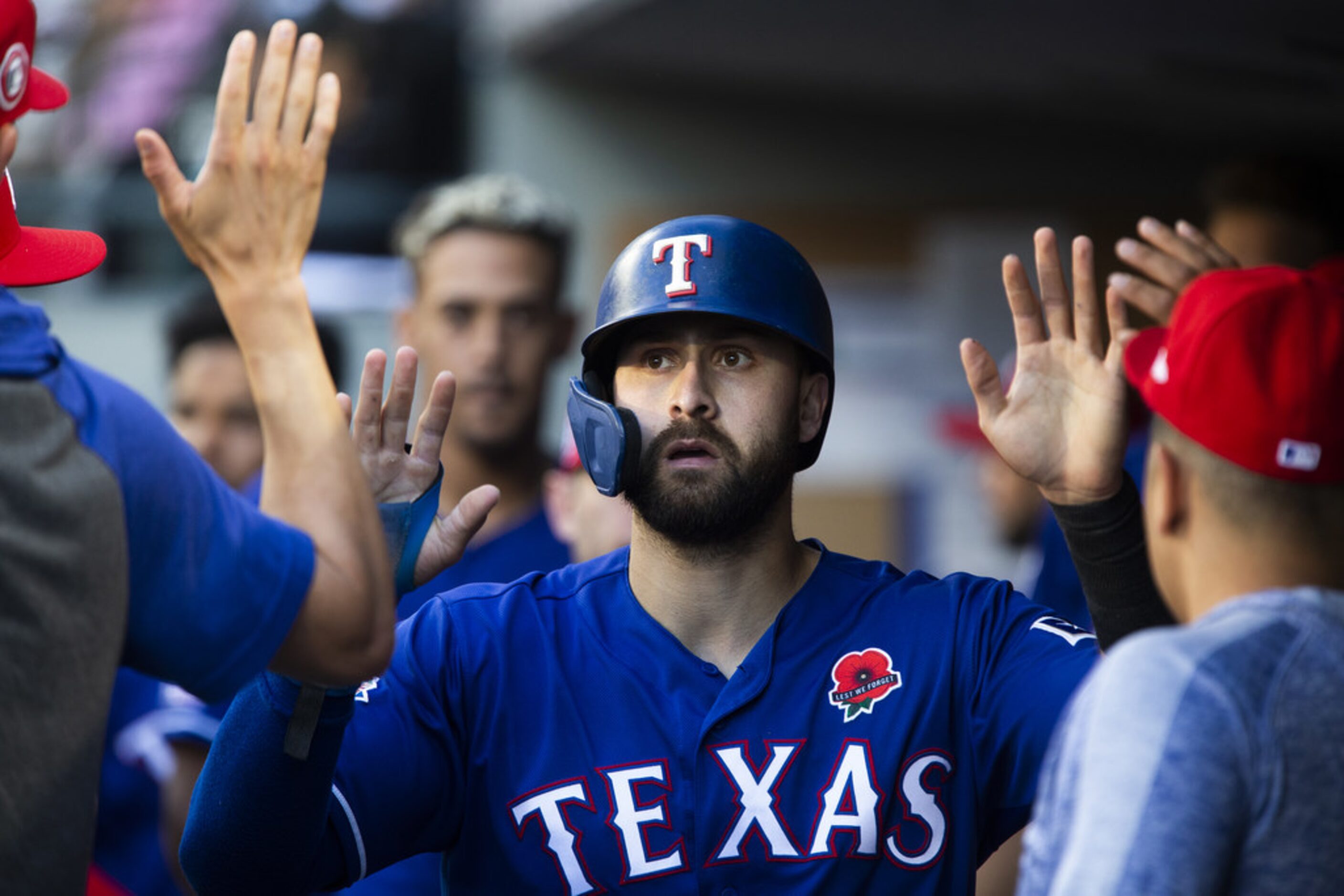 SEATTLE, WA - MAY 27:  Joey Gallo #13 of the Texas Rangers high-fives teammates in the...