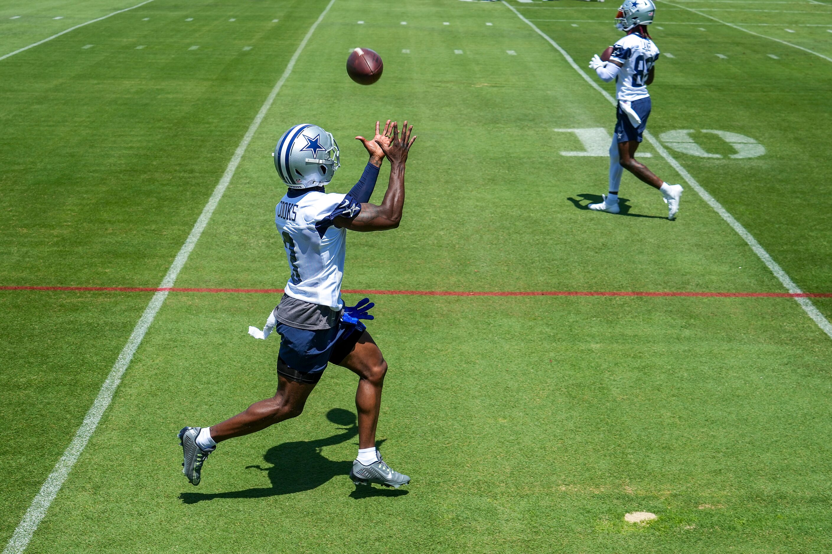 Dallas Cowboys wide receiver Brandin Cooks (3) catches a pass during the first practice of...