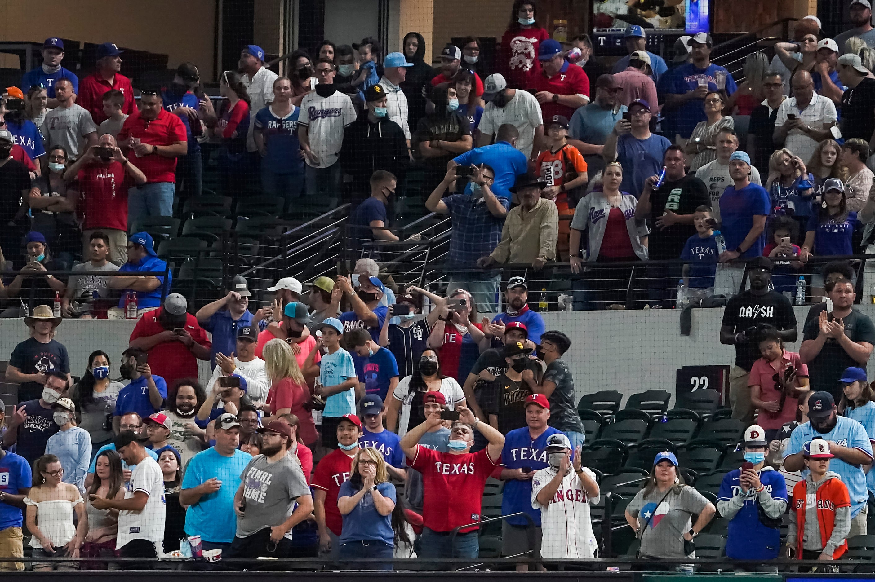 Texas Rangers fans watch as San Diego Padres players celebrate after no-hitter by Padres...