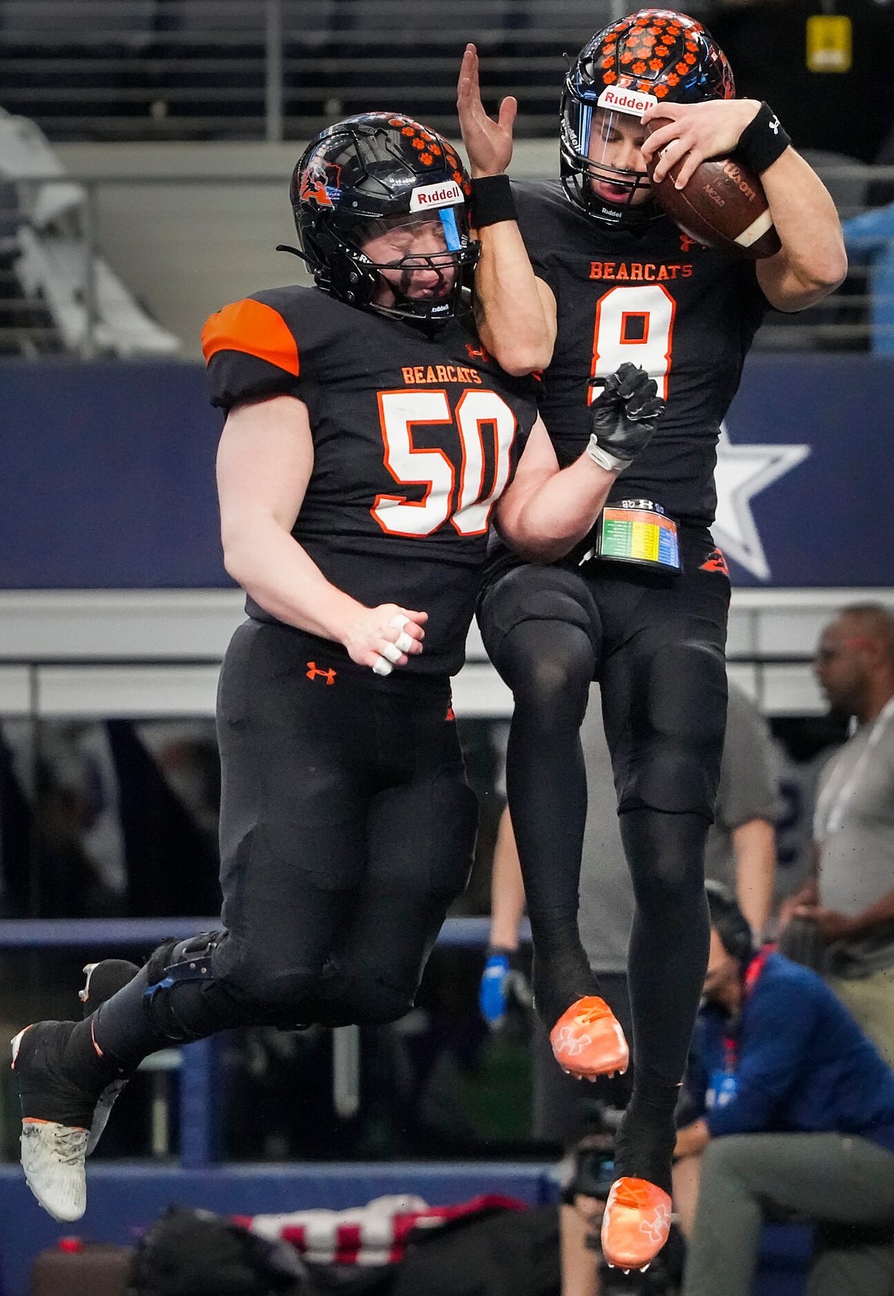 Aledo quarterback Hauss Hejny (8) celebrates with offensive lineman Alex Arana (50) after...