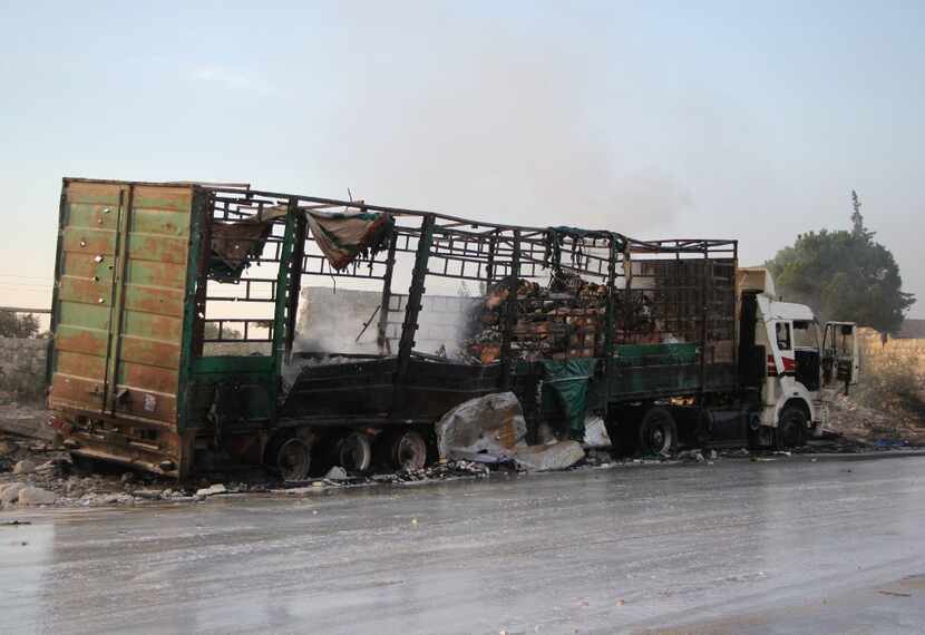 A damaged truck carrying aid is seen on the side of the road in the town of Orum al-Kubra on...