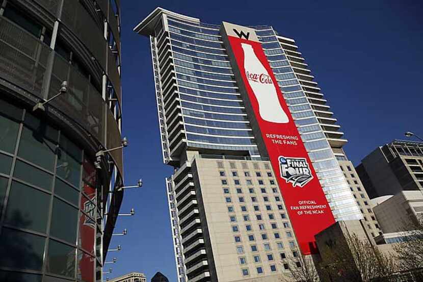A Coca-Cola banner hangs the full height of the W Hotel in Victory Plaza in Dallas for next...