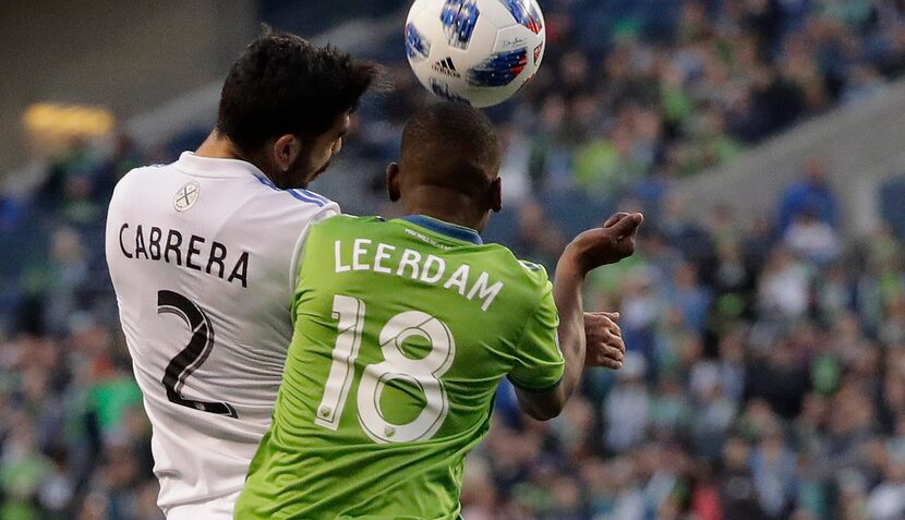 Seattle Sounders defender Kelvin Leerdam (18) battles with Montreal Impact defender Victor...