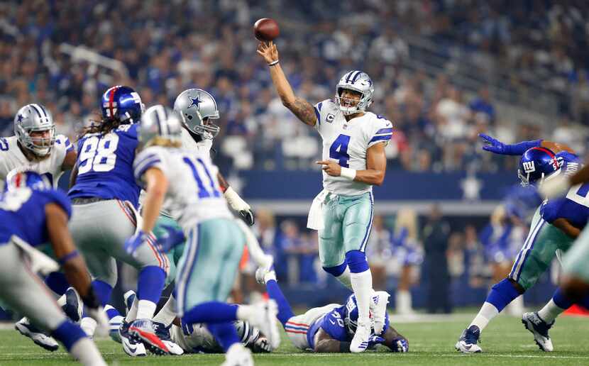 Dallas Cowboys quarterback Dak Prescott (4) throws a first half pass to wide receiver Cole...