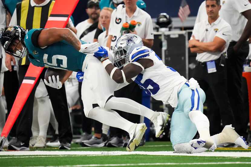 Dallas Cowboys linebacker DeMarvion Overshown (35) brings down Jacksonville Jaguars tight...