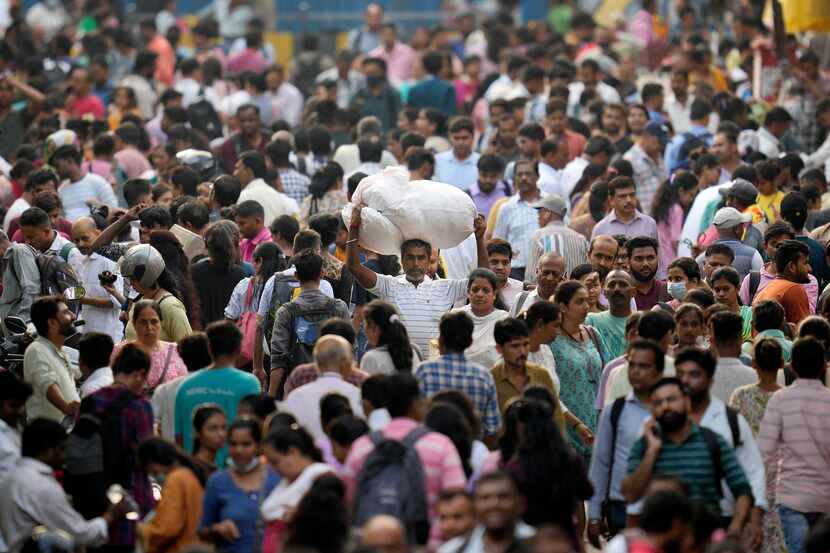People throng a marketplace in Mumbai, India, Monday, April 24, 2023. The United Nations...