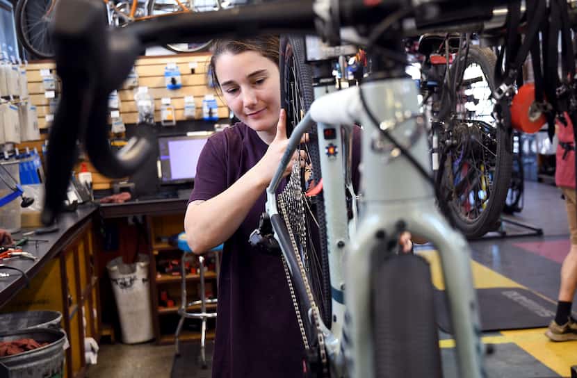 Mechanic Lizzy Thomson works at University Bicycles in Boulder, Colo., Tuesday, April 30,...
